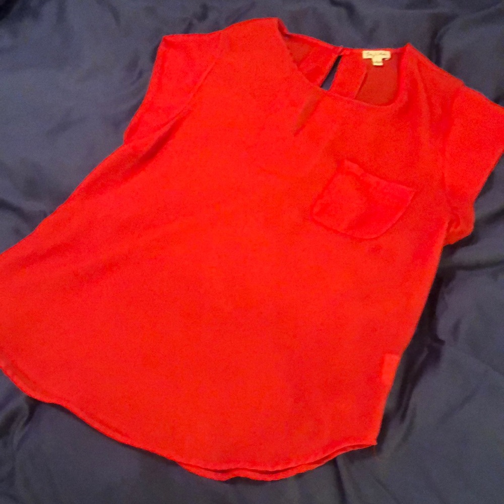 Women’s red polyester blend short sleeved blouse.